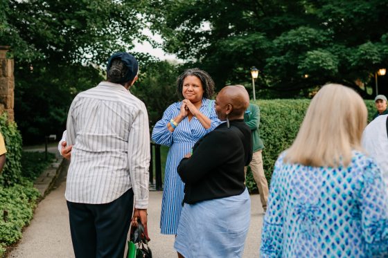 Three people standing in a small circle at Longwood Gardens.